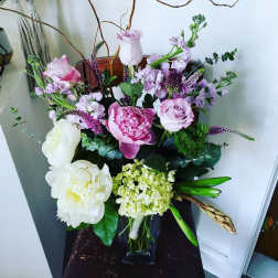 Mixed pink and white floral arrangement in a glass vase