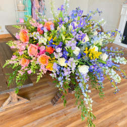 Large colorful floral arrangement on a wooden table