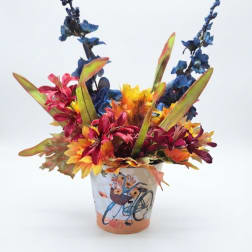 Colorful floral arrangement in a decorated ceramic pot