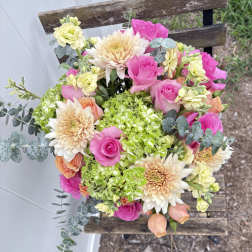 Bouquet of pink roses, cream dahlias, and green hydrangeas