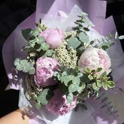 Pink peonies with eucalyptus in lavender wrapping paper