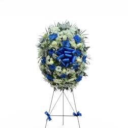 Blue and white funeral wreath on a standing easel with ribbon