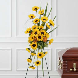 Tall sunflower standing spray beside a casket