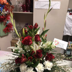 Tall red and white floral arrangement with roses, lilies, and carnations