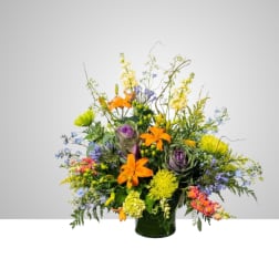 Colorful mixed flower arrangement in a dark vase