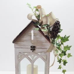 Wooden lantern with a candle and ivy ribbon decoration