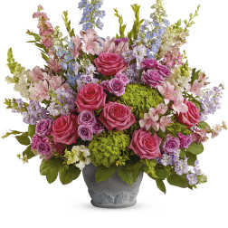 Mixed pink and lavender flowers in a gray pot