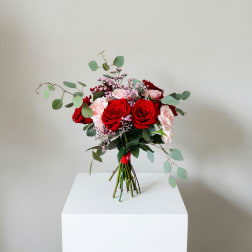 Bouquet of red and pale pink roses with airy filler and eucalyptus