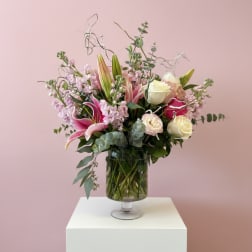 Pink and white floral arrangement in a glass vase