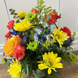 Bright mixed bouquet with yellow daisies, orange and red roses, and blue flowers