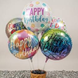 Cluster of birthday balloons in a wooden basket