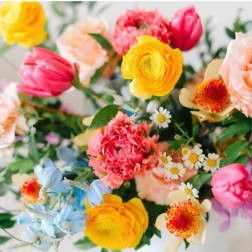 Colorful mixed bouquet with yellow, pink, peach, and blue flowers