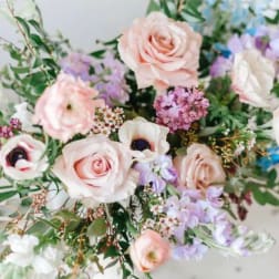 Bouquet of pale pink roses and white anemones with lavender flowers