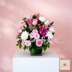 Pink and white rose bouquet with white chrysanthemums in a square vase