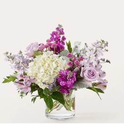 Lavender and white mixed bouquet in a clear glass vase