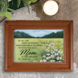 Framed Mother’s Day plaque with daisies and a candle nearby