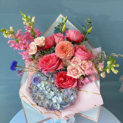 Pink and blue mixed bouquet with roses, hydrangea, and snapdragons