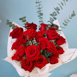 Bouquet of red roses with eucalyptus in white wrap