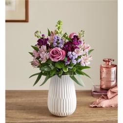 Pink and purple mixed bouquet in a white vase
