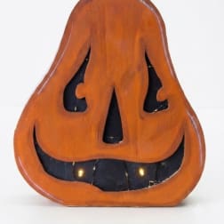 Wooden jack-o'-lantern decoration with a black stem