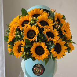 Bouquet of yellow sunflowers in a light blue hat box