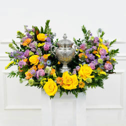 Colorful floral arrangement with a silver urn centerpiece