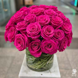 Bouquet of bright pink roses in a clear glass vase