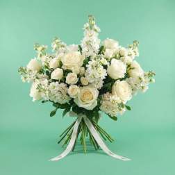 White rose bouquet with small white flowers and a ribbon tie