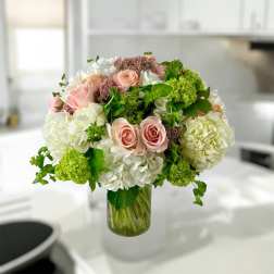 Pink roses and white hydrangeas in a glass vase