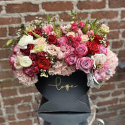 Mixed pink and red rose bouquet in a black box