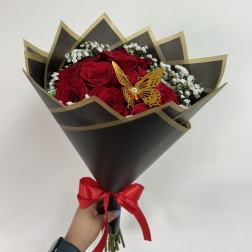 Bouquet of red roses with white baby's breath in black wrapping