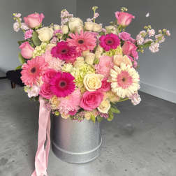 Pink and cream mixed bouquet in a silver hatbox with a pink ribbon