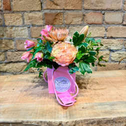 Pink and peach bouquet in a pink gift bag with rope handles