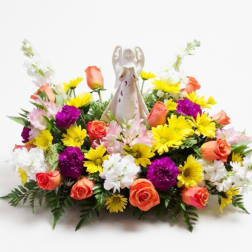 Colorful floral arrangement with an angel figurine in the center