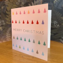 A pink Christmas card with multicolored tree icons and "Merry Christmas" text.