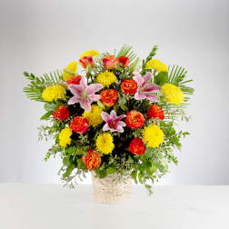 Basket arrangement of pink lilies, red roses, and yellow chrysanthemums
