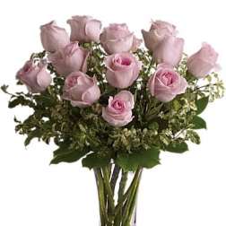 Bouquet of pale pink roses in a clear glass vase