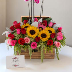 Wooden box arrangement with roses, sunflowers, and pink orchids