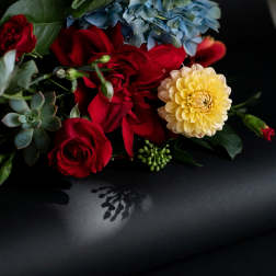 Gift card with a floral arrangement of red roses, blue hydrangea, and a yellow dahlia