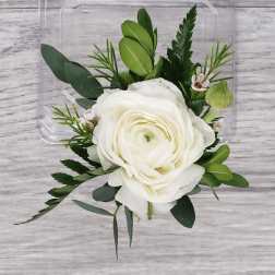 White ranunculus-style bloom with greenery on a clear plastic backing