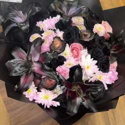 Bouquet of pink and black flowers wrapped in black paper