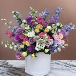 Mixed pastel bouquet in a white cylindrical box