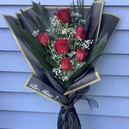 Bouquet of red roses with baby's breath in black and gold wrap