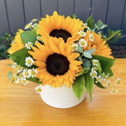 Sunflower bouquet in a white vase with small white daisies