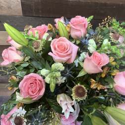 Pink roses and mixed blooms arranged in a bouquet
