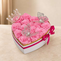 Heart-shaped box of pink roses with butterfly toppers and a crown