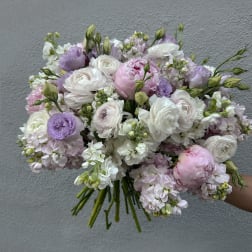 Handheld bouquet of white, pink, and lavender flowers