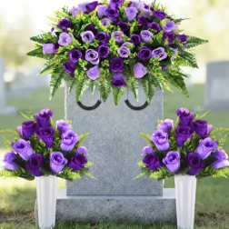 Purple rose funeral arrangement on a gravestone with two matching vase bouquets