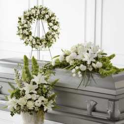 White floral funeral casket spray, wreath, and basket arrangement
