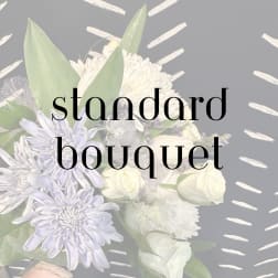 White and pale lavender bouquet with large blooms and broad leaves